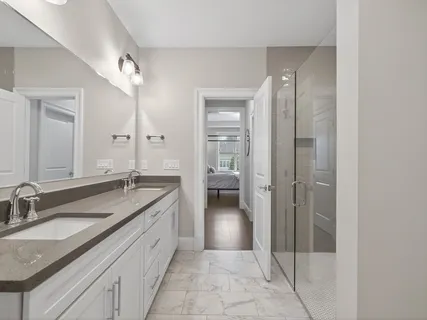 a spacious bathroom with a granite countertop sink mirror and toilet