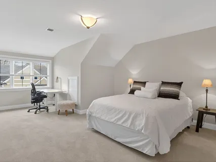 a bedroom with bed and a chandelier