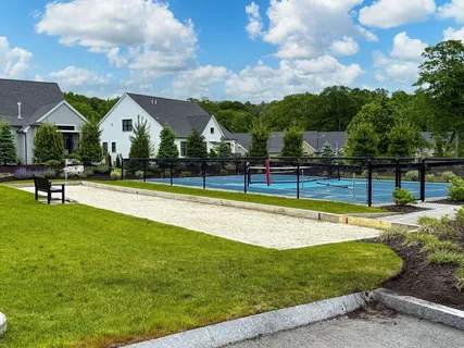 a view of a house with swimming pool and sitting area