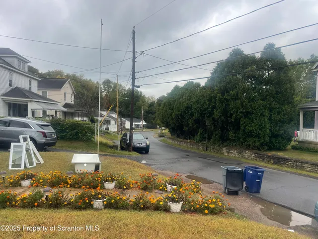 a view of a swimming pool with a patio and a yard
