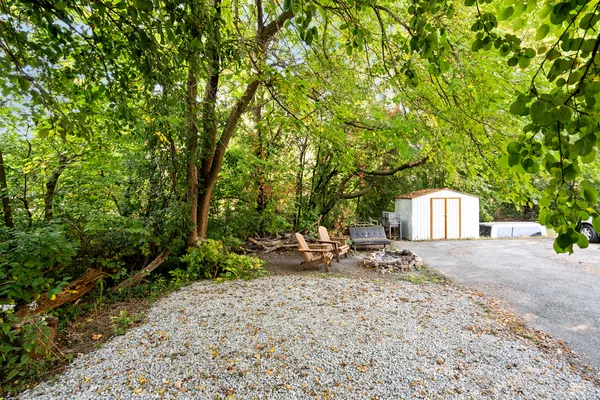 a backyard of a house with yard and outdoor seating
