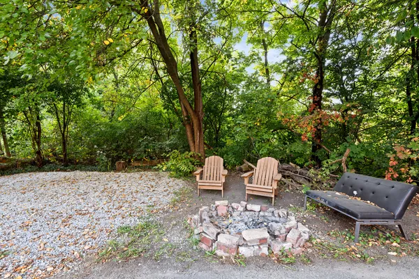 a wooden bench sitting in the middle of a backyard