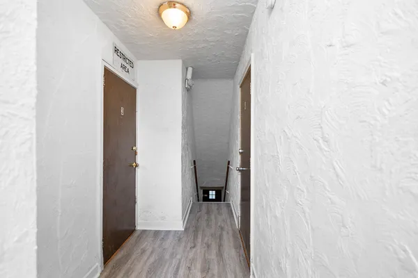 a view of a hallway with wooden floor