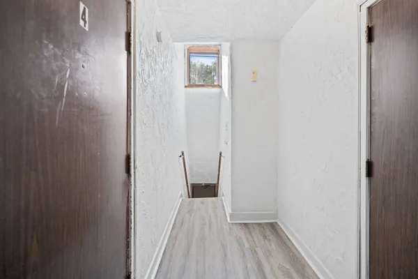 a view of a small space with wooden floor