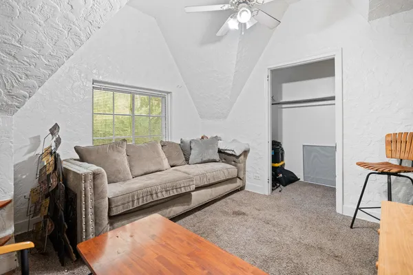a living room with furniture a lamp and a window