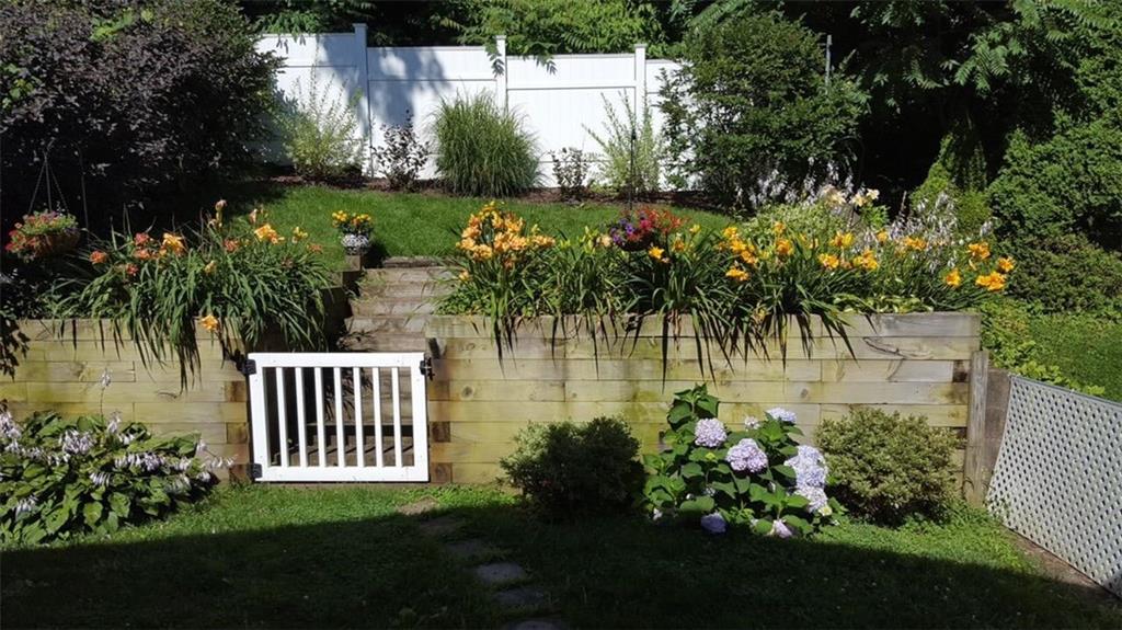 1542 Rutherford Avenue Pittsburgh, PA 15216 - Photo 16 of 16 Another wonderful shot of the backyard in full bloom! The addt'l lot is just on the other side of the white fence. So much potential to expand this already-incredible outdoor space.