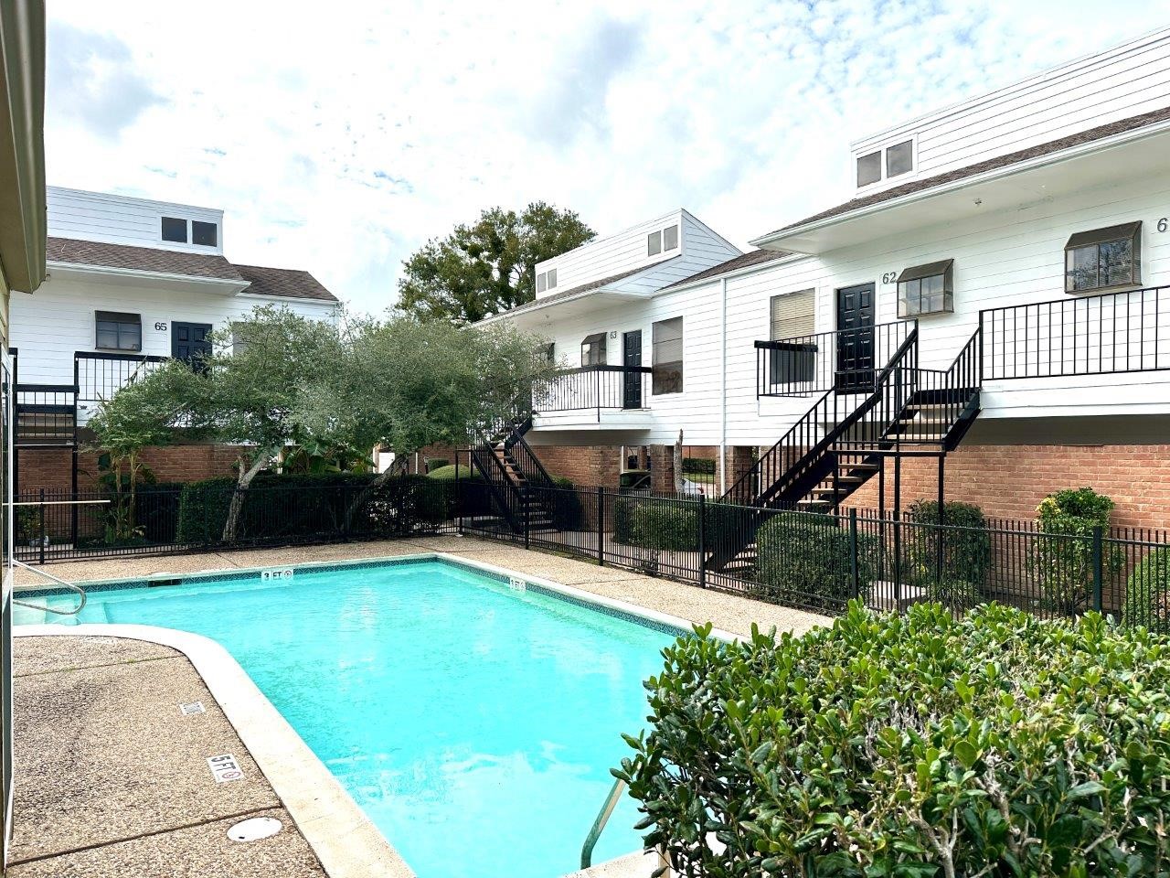 a view of a house with pool porch and chairs
