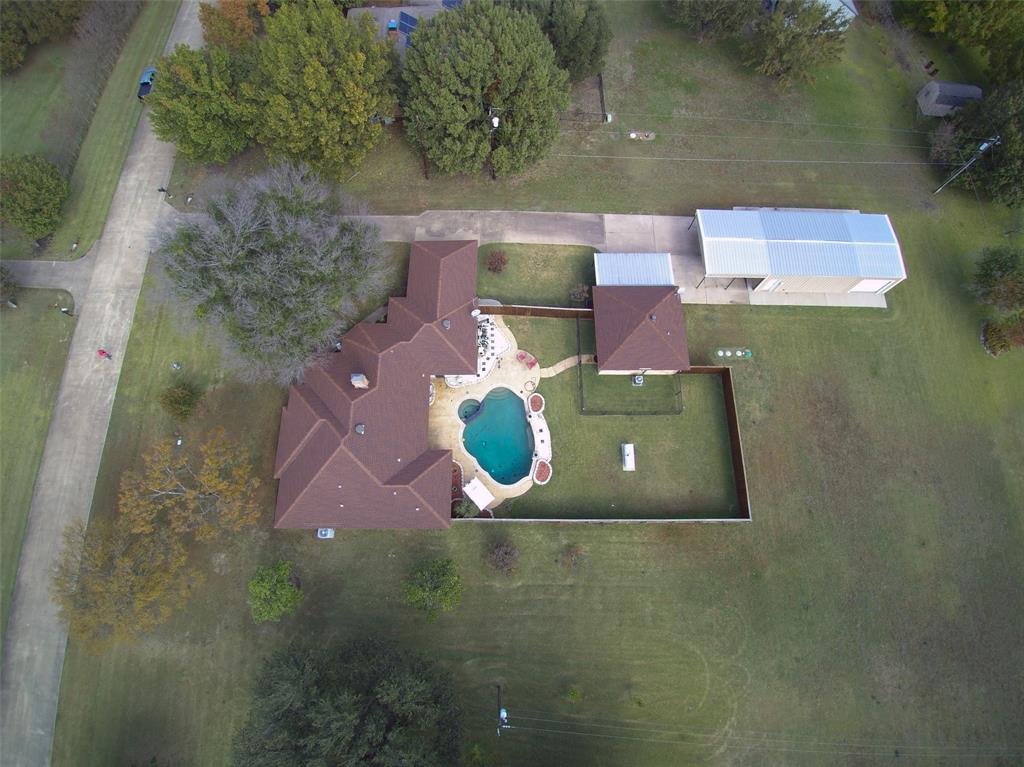 an aerial view of a house with a yard