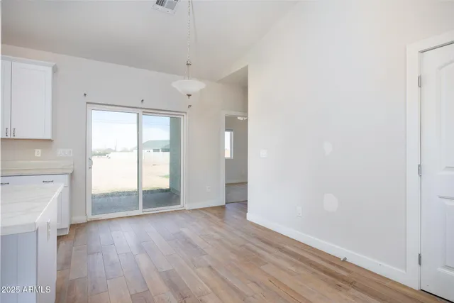 a kitchen with stainless steel appliances granite countertop a sink a stove a refrigerator and island with wooden floor