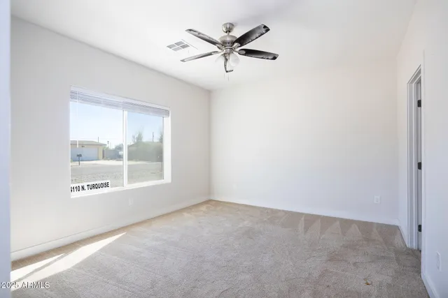 a view of a room with a ceiling fan and closet in a bathroom