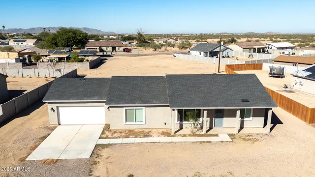 an aerial view of residential houses with city view