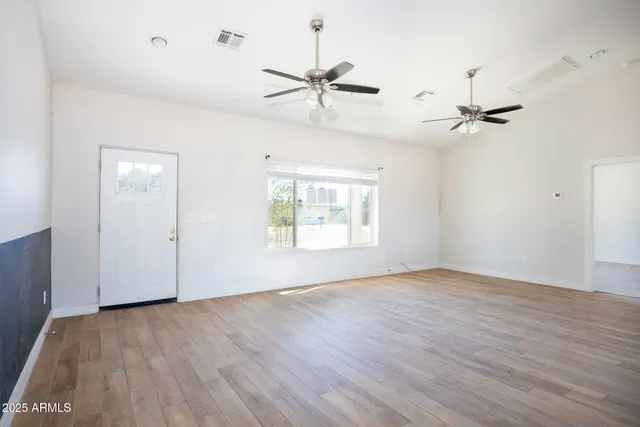 a kitchen with a sink a stove a refrigerator and white cabinets