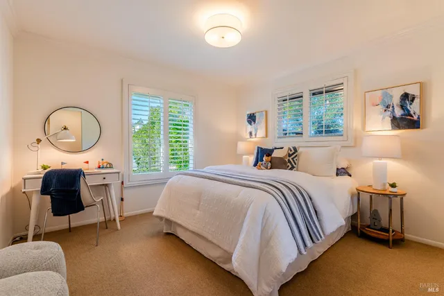 a bed room with a bed and a chair