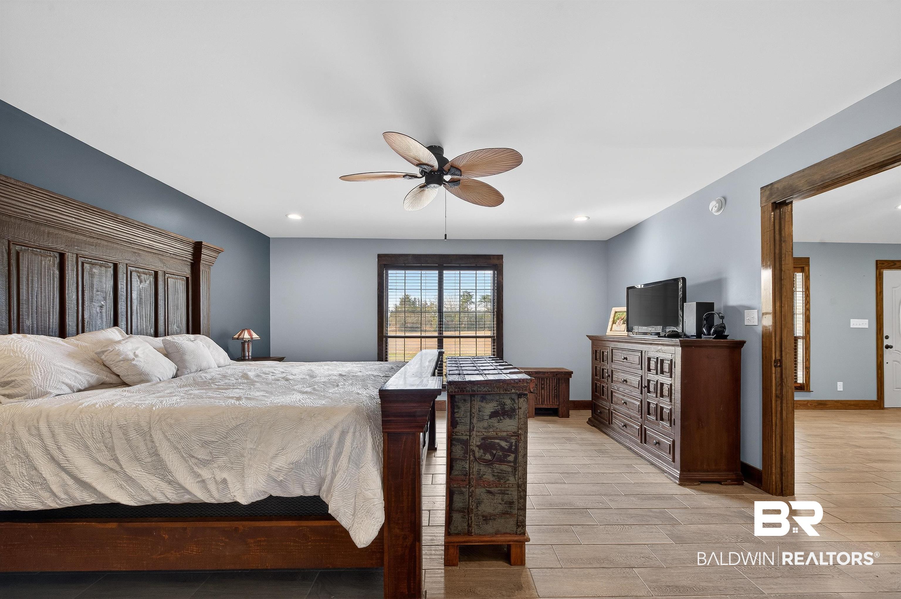 29635 Gardner Road Elberta, AL 36530 - Photo 24 of 66 Bedroom with a ceiling fan, recessed lighting, and wood tiled floors