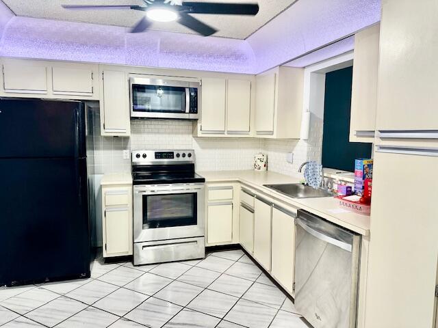 18730 Stewart Circle, Unit 5 Boca Raton, FL 33496 - Photo 3 of 24 a kitchen with a sink stove and microwave