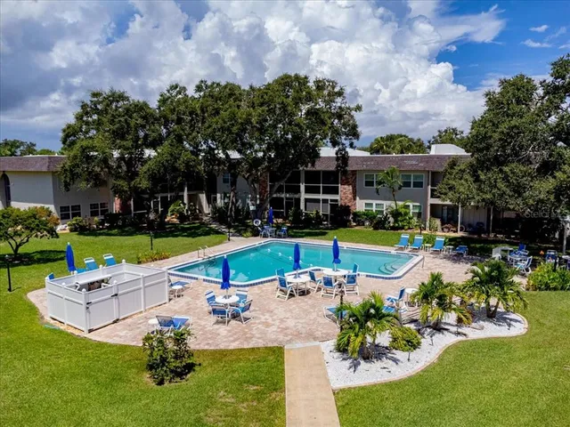 a view of a house with swimming pool and yard with green space