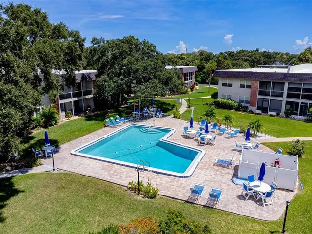 an aerial view of a house with a garden and swimming pool
