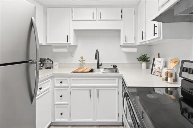 a kitchen with cabinets appliances and a counter space