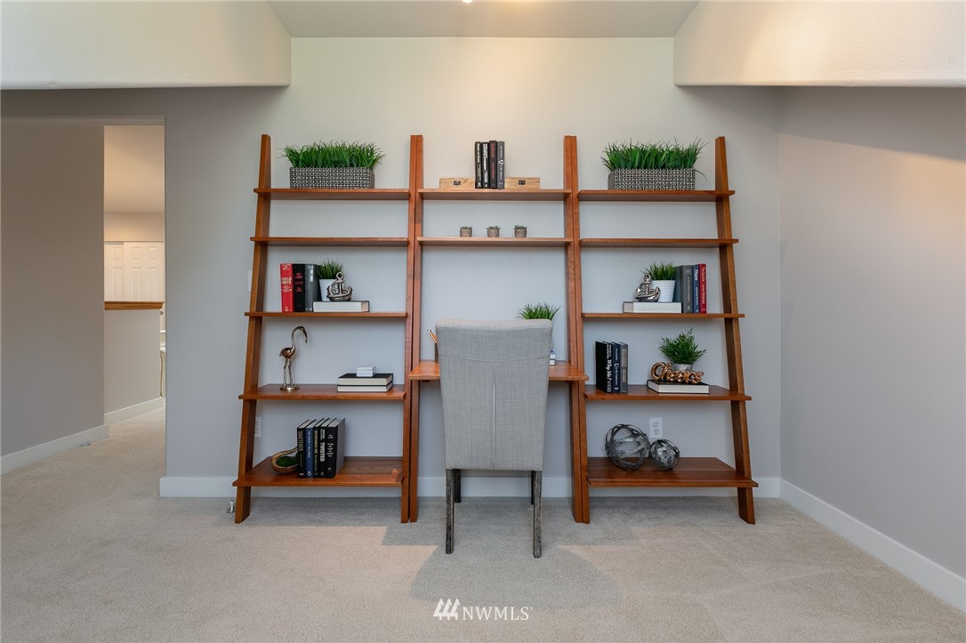 204 203rd Street Southeast Bothell, WA 98012 - Photo 12 of 25 a living room with furniture and a book shelf