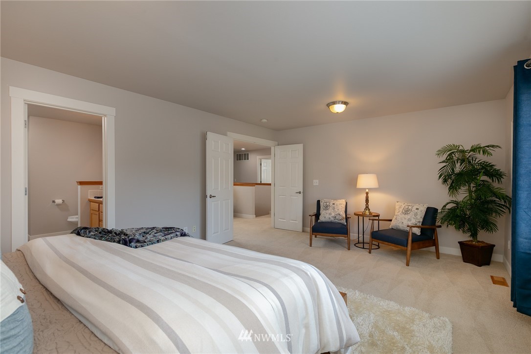 204 203rd Street Southeast Bothell, WA 98012 - Photo 14 of 25 a bedroom with a bed and a potted plant