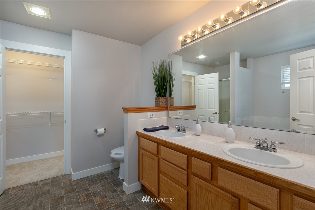 204 203rd Street Southeast Bothell, WA 98012 - Photo 15 of 25 a bathroom with a double vanity sink toilet and mirror