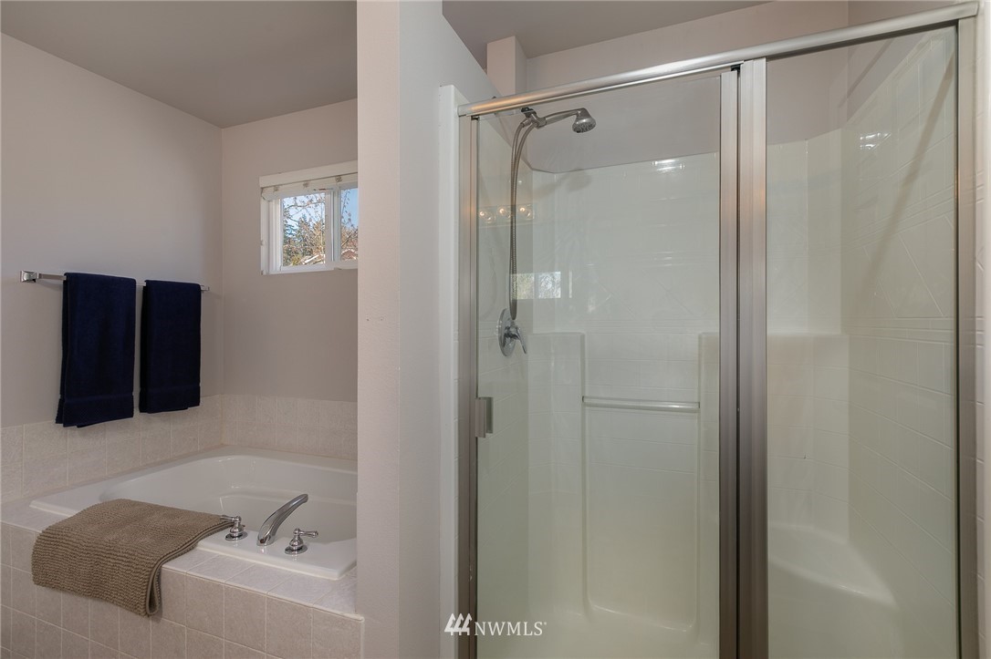 204 203rd Street Southeast Bothell, WA 98012 - Photo 16 of 25 a bathroom with a bathtub and a shower