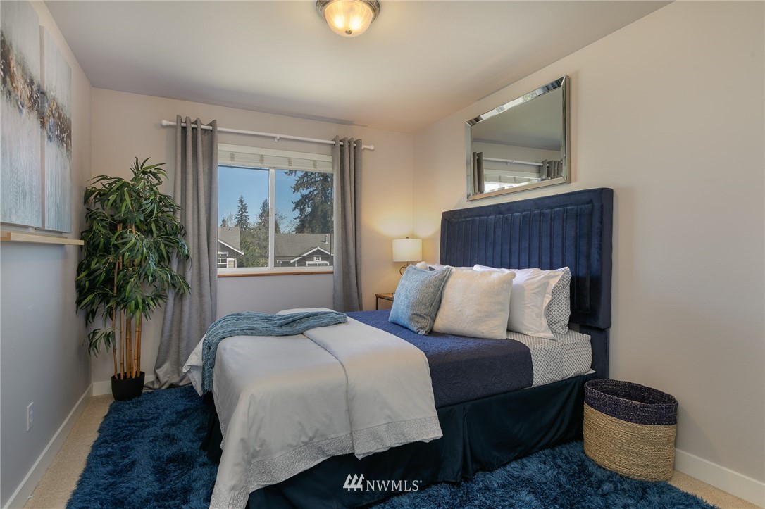 204 203rd Street Southeast Bothell, WA 98012 - Photo 18 of 25 a bedroom with a large bed and a potted plant