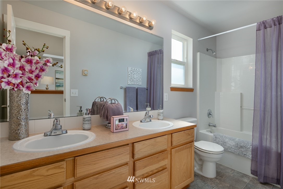 204 203rd Street Southeast Bothell, WA 98012 - Photo 19 of 25 a bathroom with a granite countertop sink toilet a large mirror and shower