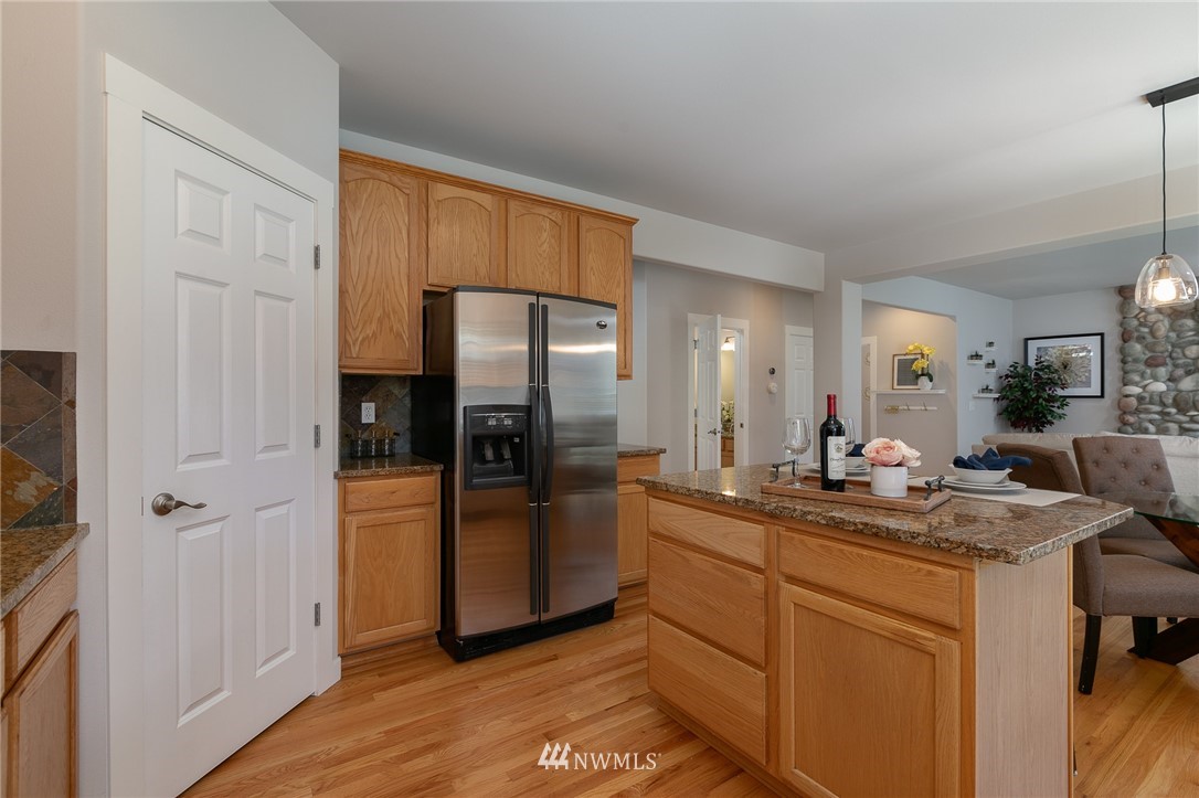 204 203rd Street Southeast Bothell, WA 98012 - Photo 6 of 25 a kitchen with stainless steel appliances granite countertop a refrigerator and a sink