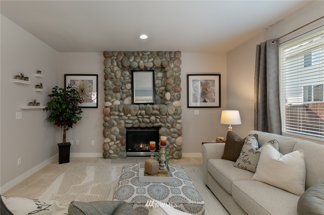 204 203rd Street Southeast Bothell, WA 98012 - Photo 8 of 25 a living room with furniture and a fireplace