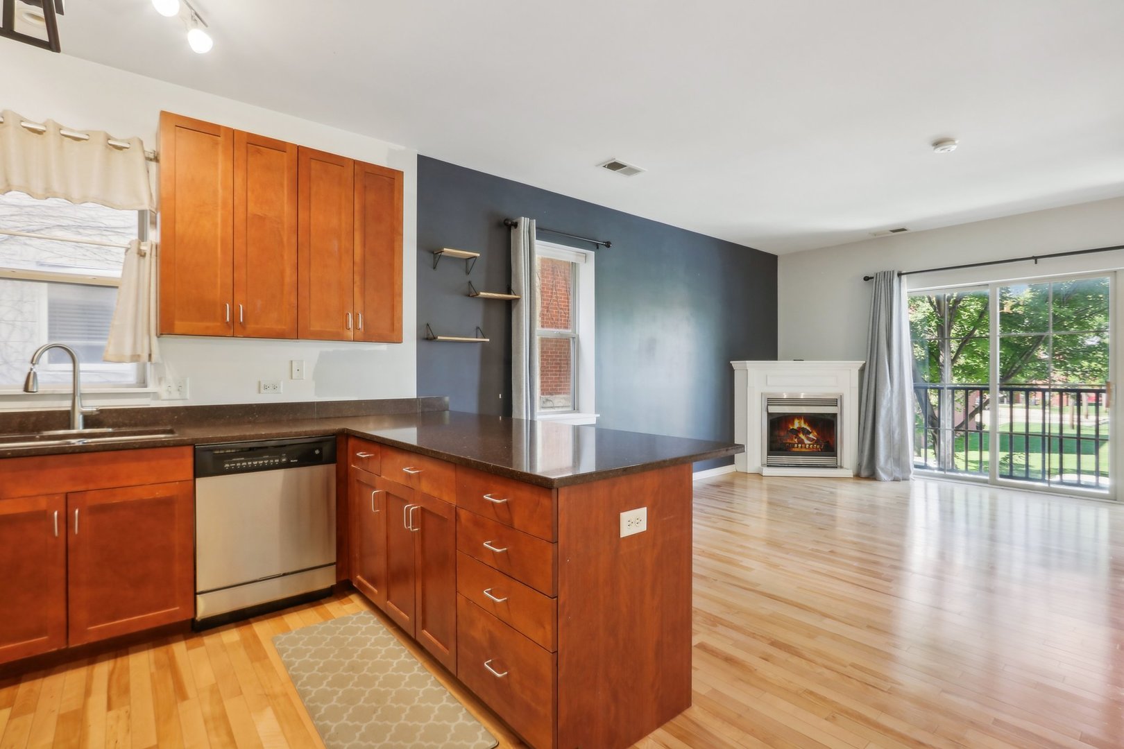 1033 South Lytle Street, Unit 201 Chicago, IL 60607 - Photo 14 of 35 a kitchen with stainless steel appliances granite countertop a stove a sink and a refrigerator with wooden floor