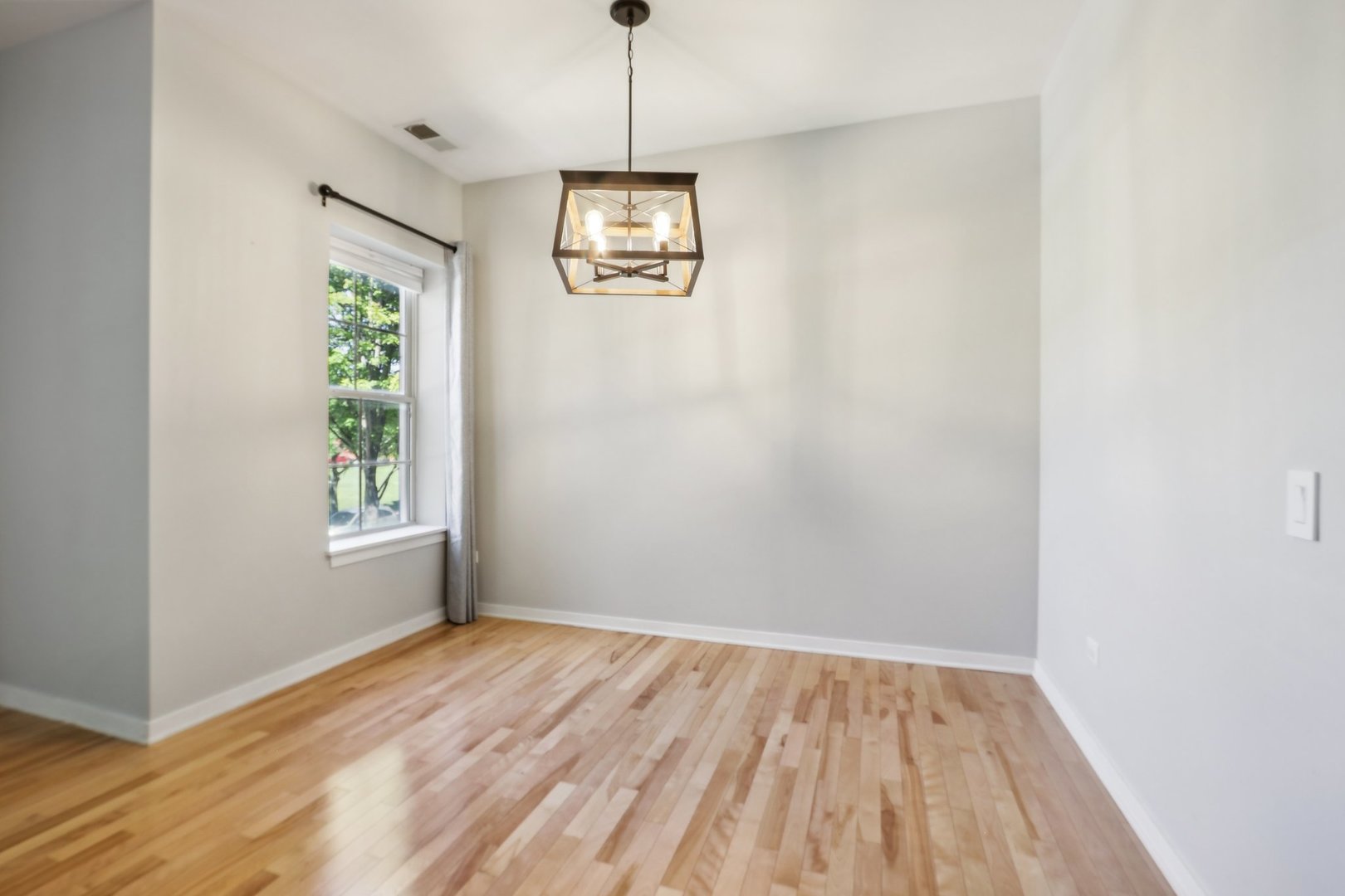 1033 South Lytle Street, Unit 201 Chicago, IL 60607 - Photo 3 of 35 a view of empty room with window and wooden floor