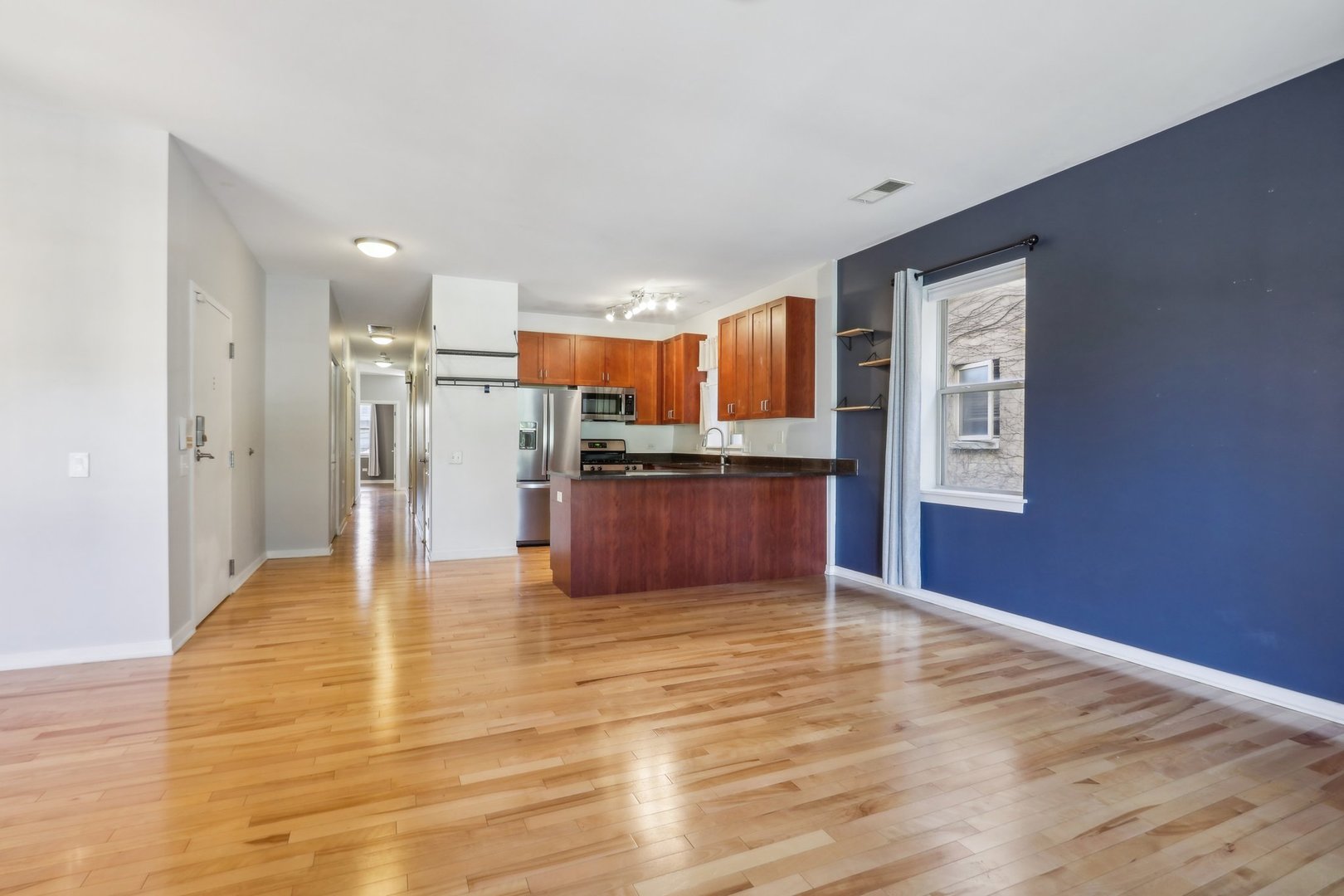 1033 South Lytle Street, Unit 201 Chicago, IL 60607 - Photo 9 of 35 a view of kitchen with refrigerator microwave and wooden floor