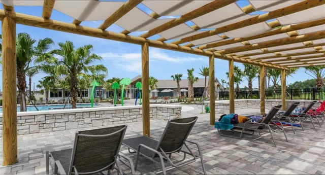 a view of a porch with furniture and a backyard