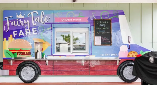 a utility room with stainless steel appliances wooden floor and window