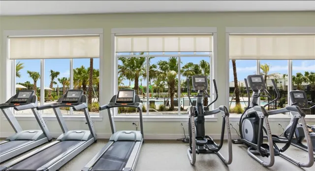 a very nice looking room with many windows and furniture