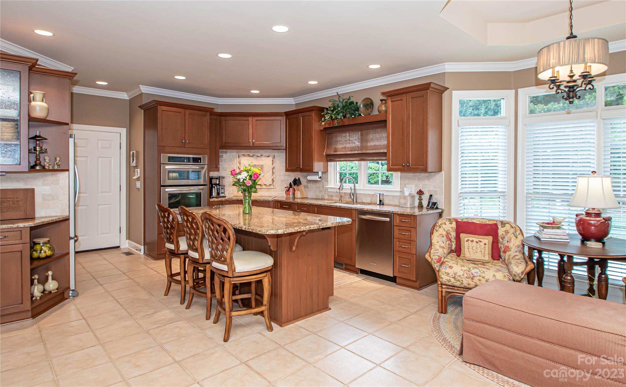 2100 Peterborough Lane Charlotte, NC 28270 - Photo 12 of 48 a kitchen with a dining table chairs and view kitchen