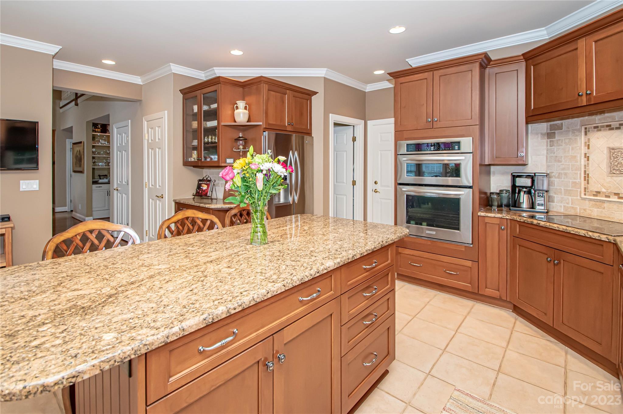 2100 Peterborough Lane Charlotte, NC 28270 - Photo 13 of 48 a kitchen with stainless steel appliances kitchen island granite countertop a sink refrigerator and cabinets