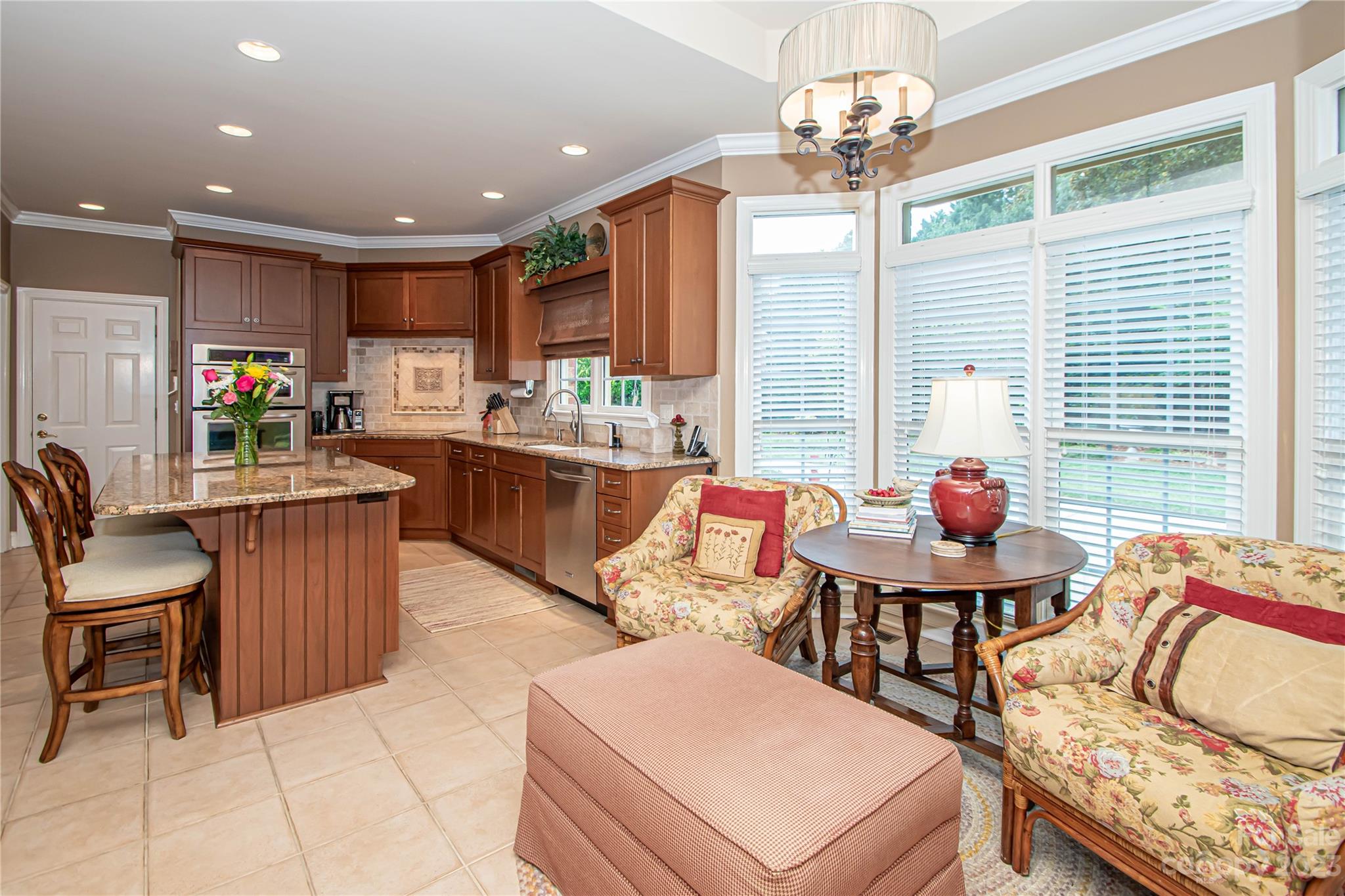 2100 Peterborough Lane Charlotte, NC 28270 - Photo 14 of 48 a living room with kitchen island furniture and a chandelier