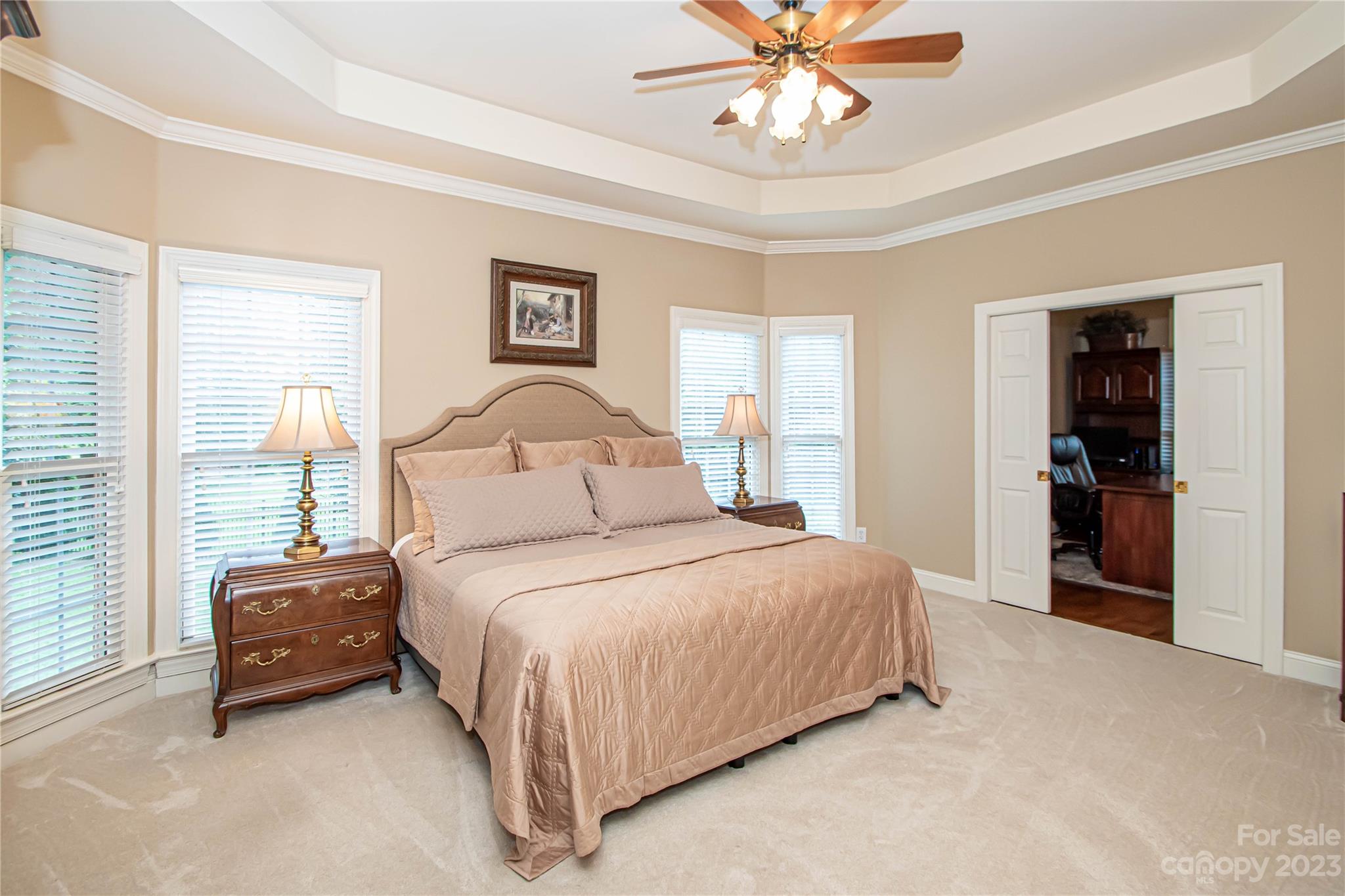 2100 Peterborough Lane Charlotte, NC 28270 - Photo 25 of 48 a bedroom with a large bed and a chandelier