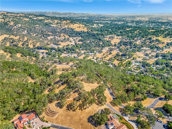 an aerial view of residential houses with city view