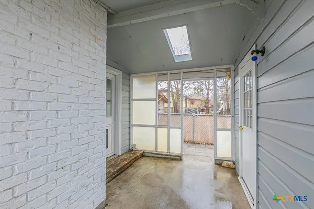 a view of a patio with table and chairs and potted plants