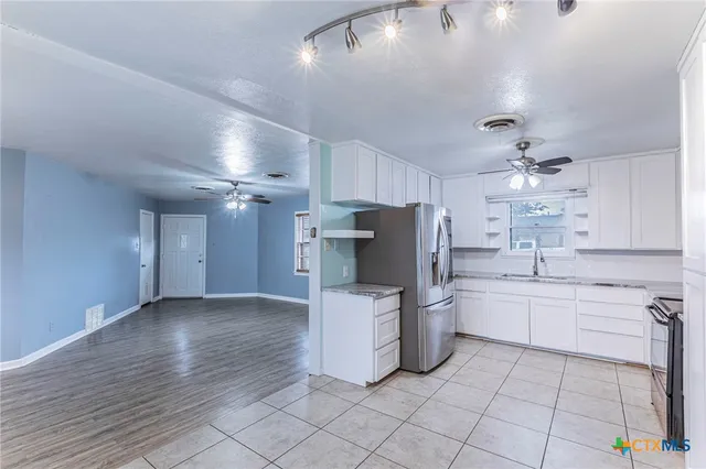 a kitchen with a refrigerator and a sink