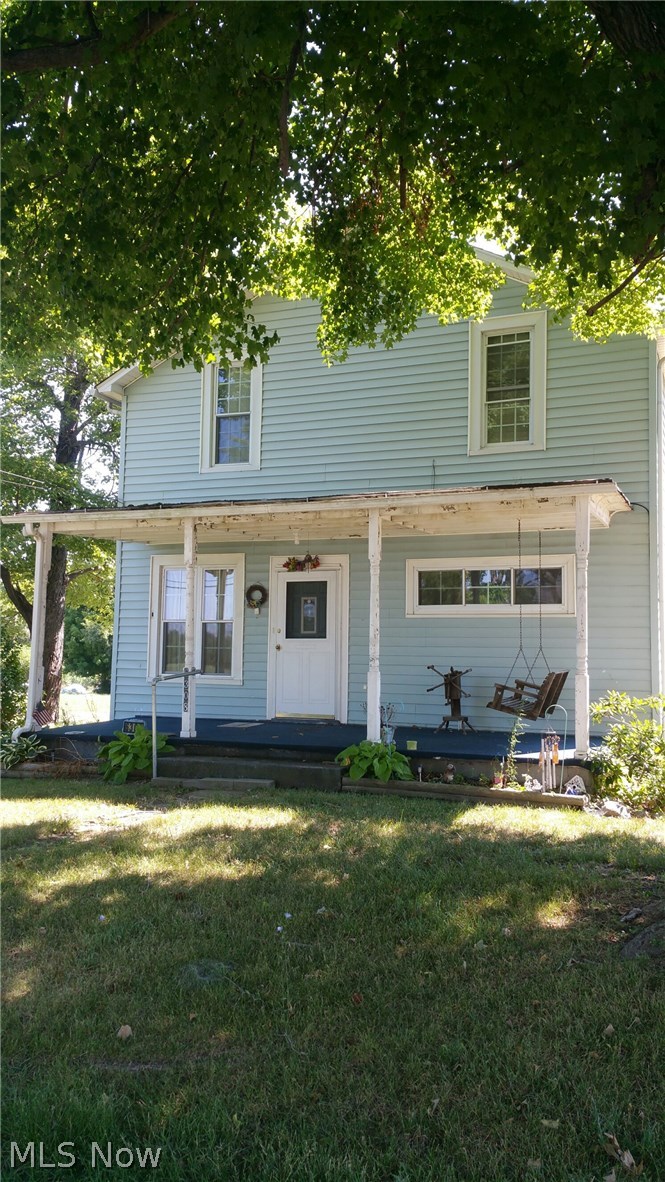 6308 Wayland Road Ravenna, OH 44266 - Photo 3 of 22 Second view of front of house with porch shaded by large tree.