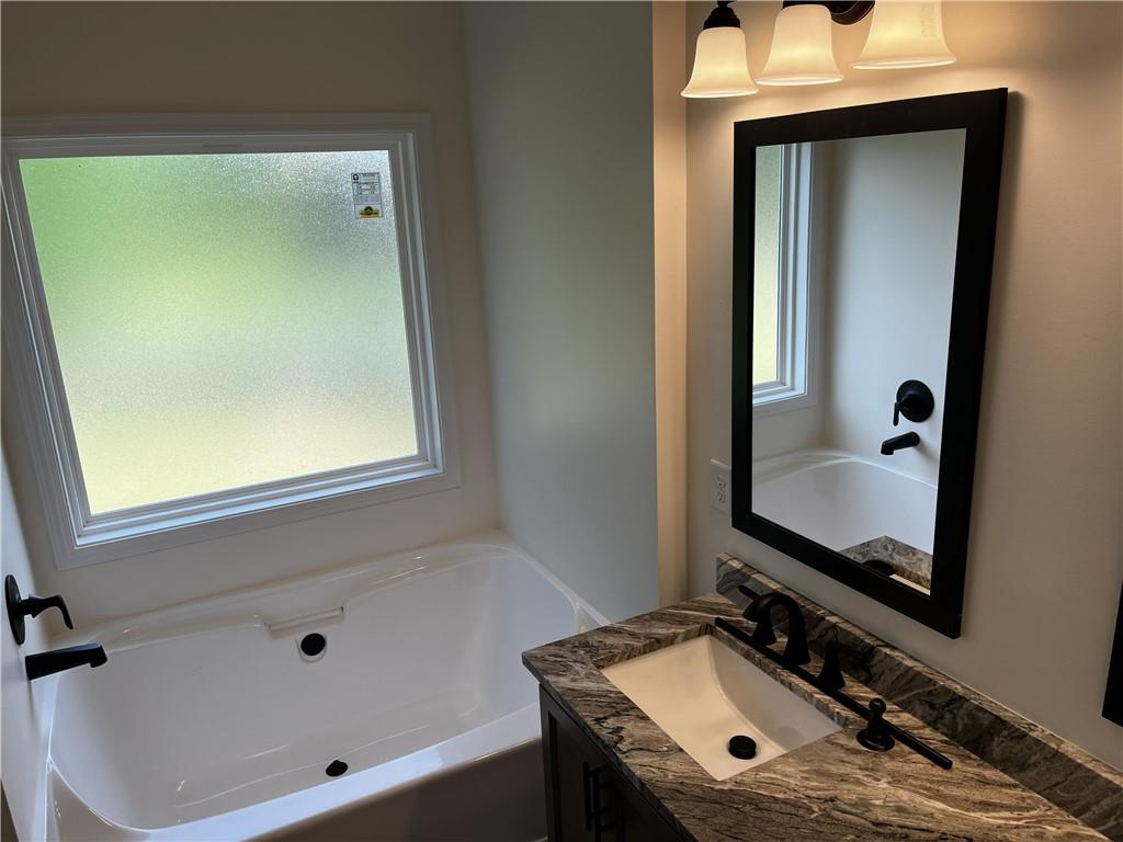 1932 Cochran Ridge Road Hiram, GA 30141 - Photo 23 of 30 a bathroom with a sink and a mirror