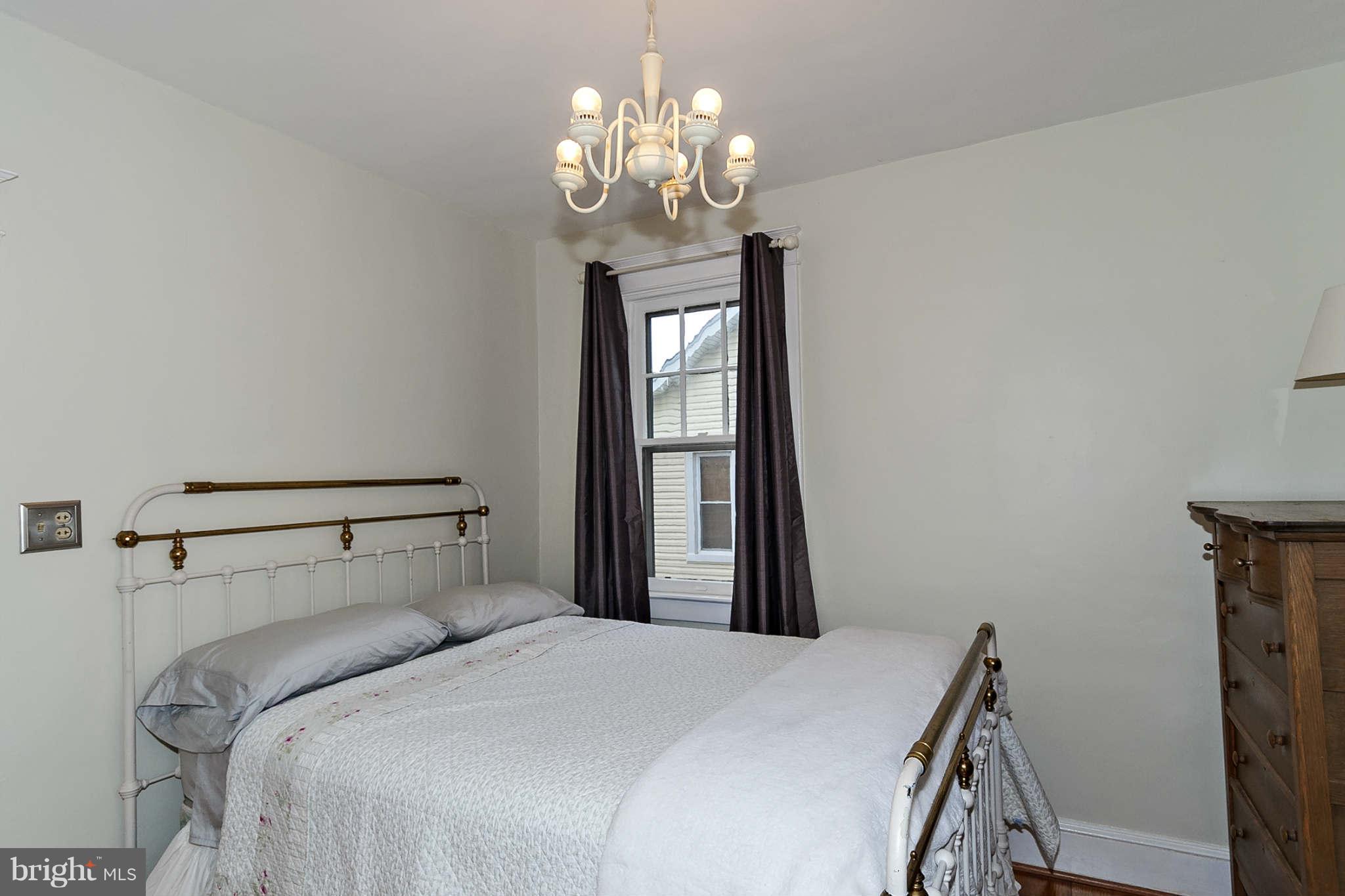 31 Edmondson Ridge Road Baltimore, MD 21228 - Photo 12 of 22 a bedroom with a bed and a chandelier
