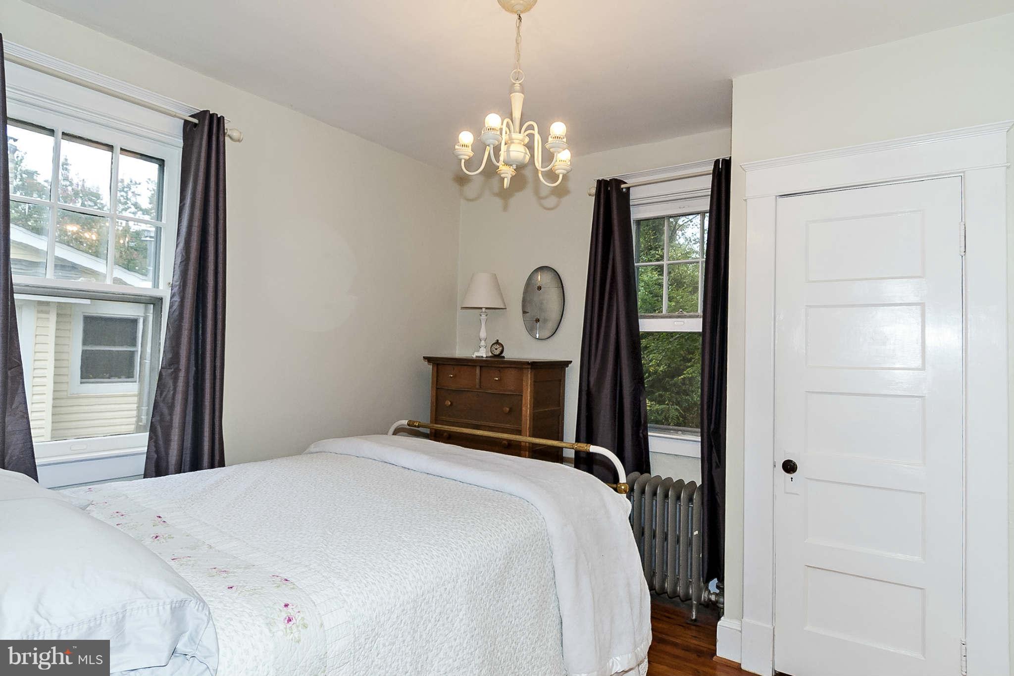 31 Edmondson Ridge Road Baltimore, MD 21228 - Photo 13 of 22 a bedroom with a bed and a chandelier