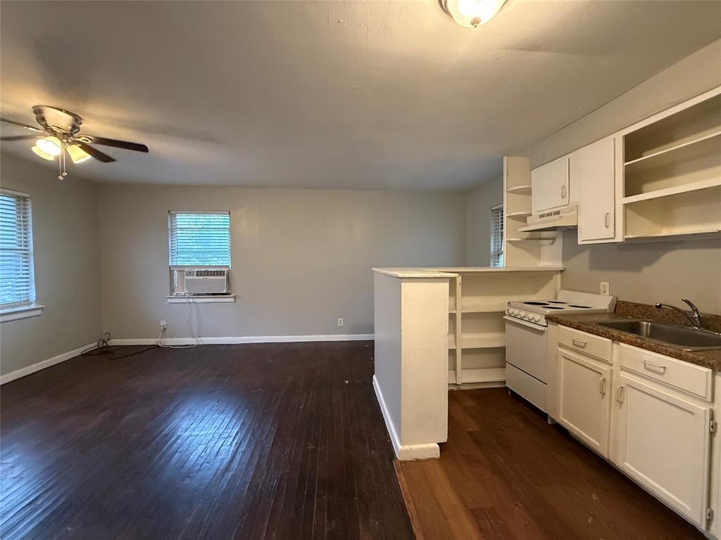 4815 Live Oak Street, Unit 10 Dallas, TX 75204 - Photo 11 of 13 Kitchen featuring open shelves, white electric stove, white cabinetry, and dark countertops