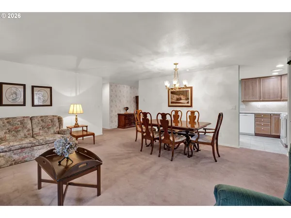 a living room with furniture a dining table and a fireplace