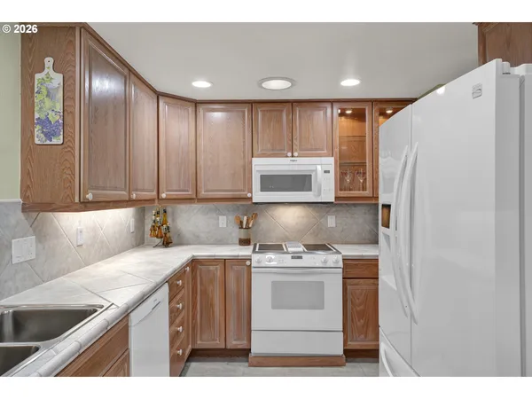 a kitchen with a sink a refrigerator and cabinets